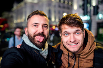 Two men walking in the streets of London at night