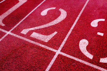 the starting block on a running track showing the numbers 1, 2 and 3