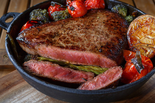 Beef steak with vegetables on a cast-iron frying pan.homemade food