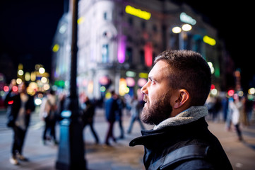 Man walking in the streets of London at night