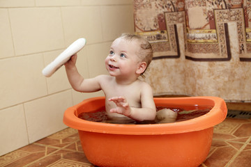 Toddler in a basin with water