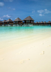 beach with water bungalows at Maldives