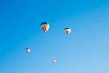  air balloons flying over the valley at Cappadocia