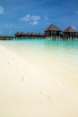 beach with water bungalows at Maldives