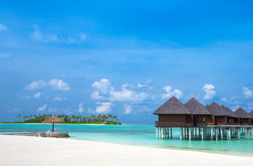 beach with water bungalows at Maldives