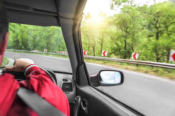 Hands on wheel of a car.