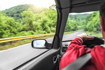 Hands on wheel of a car.