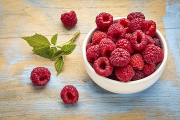 fresh red raspberries with green leaf