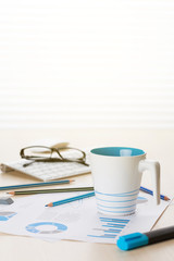 Office workplace with supplies and reports