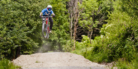 Professional athlete high jump on a mountain bike.
