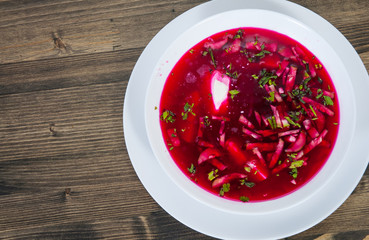 Vegetable cold soup with beet, cucumber, radsih and egg  on wooden table