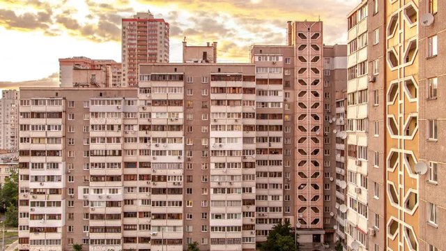  Beautiful and colorful sunset in the city. In the high rise house begin to glow window. Transition day into night. Timelapse. Kiev, Ukraine