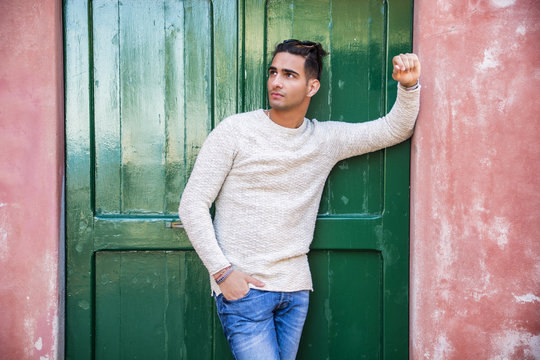 Elegant Young Man Leaning Against Door