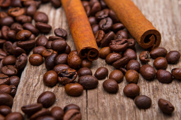 Coffee beans and cinnamon stick. Brown coffee grains and cinnamon. Spice for beverages. Aroma of robusta.