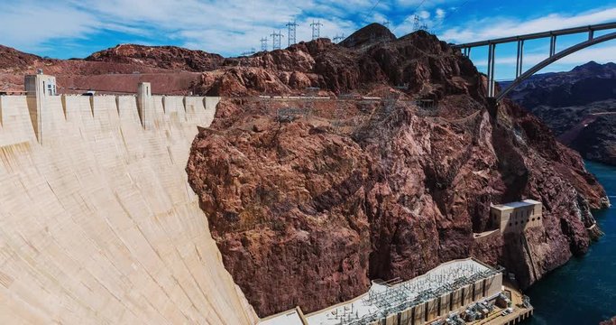 Hoover Dam Panning Right Time Lapse. time lapse pans right from the large hoover dam to show the large bridge connecting the states of Arizona and Nevada
