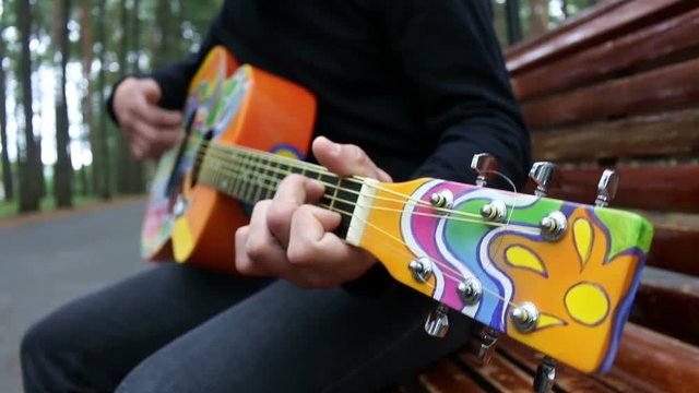 Guy plays guitar hippie style
