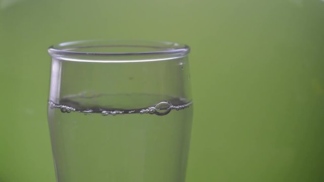 Serving a glass of water. Filling a glass with water.
