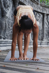 Fototapeta na wymiar Asian young woman doing yoga in abandoned temple