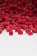 fresh organic raspberries. Summer berries dessert and snacks cattered on white background. Healthy food and summer concept