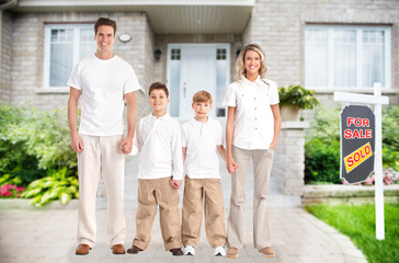 Happy family near new house.