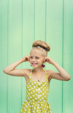 Beautiful girl holding cherries as earrings -style Rockabilly.