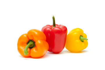 Bulgarian peppers of different colors on a white background.