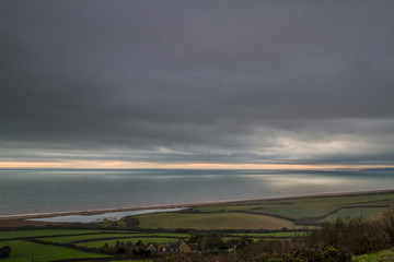 stormy skies over English country and sea