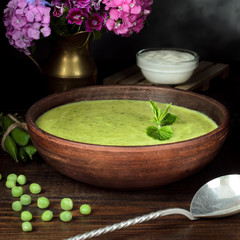 Vegetarian fresh pea cream soup, still life