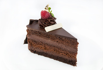 piece of chocolate cream cake on a white background in the restaurant