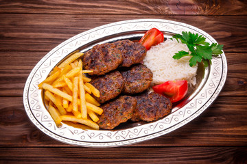 Meat kebab beef balls with rice and fried potatoes