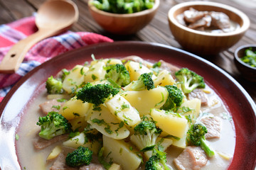 Pork with broccoli, ginger root and boiled potatoes