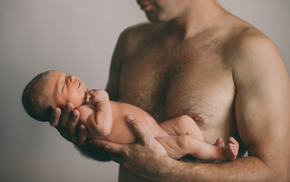 Newborn baby in dad's hands
