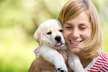 Girl with labrador puppy