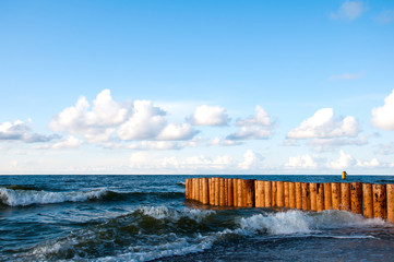 Obraz premium Breakwater on sea and blue sky