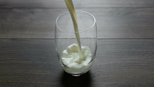 Pouring a glass of milk - slow motion