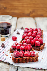 chocolate tart with chocolate filling and fresh raspberries