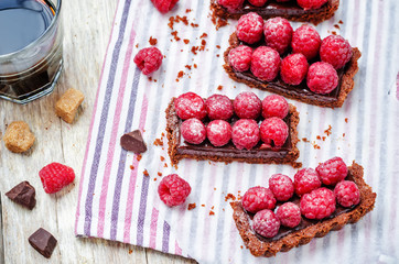 chocolate tart with chocolate filling and fresh raspberries