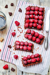 chocolate tart with chocolate filling and fresh raspberries