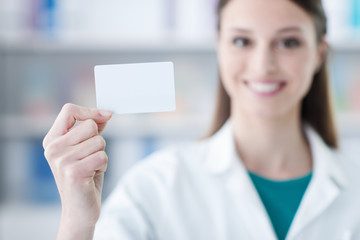Female doctor holding a business card