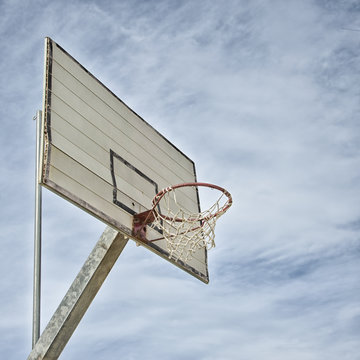 Isolated old basketball hoop with sky background