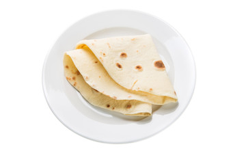 Wheat tortilla on plate isolated on white