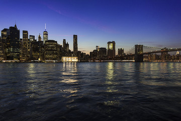 Fototapeta na wymiar New York City Manhattan skyline and cityscape at twilight with Brooklyn Bridge 