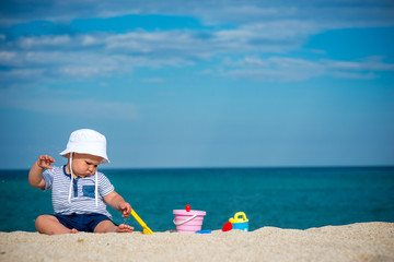 Fototapeta na wymiar Boy playing with toys on beach