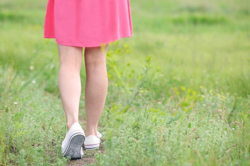 Woman legs on green grass