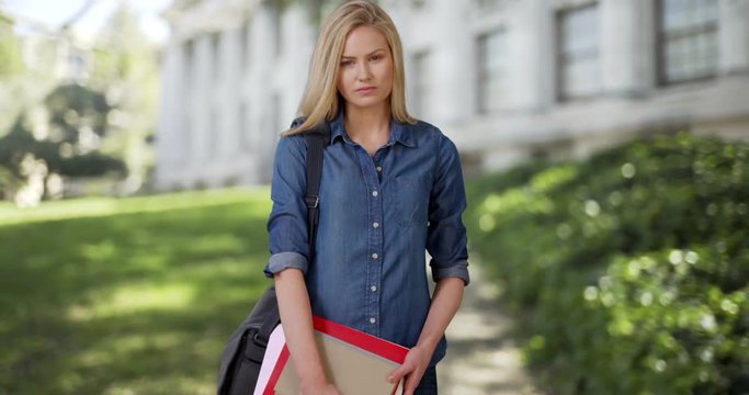 Charming young female student on her way to class