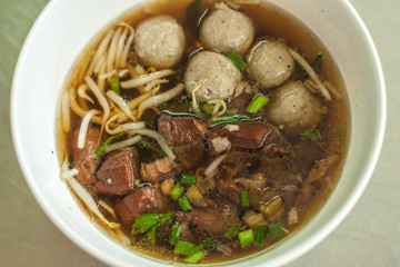 Thai noodle and soup with pork meatball and pork on the table