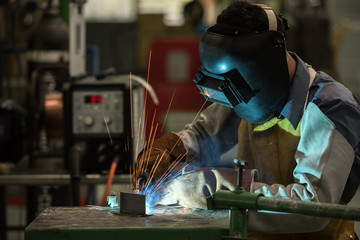 Welding worker in factory