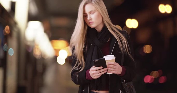 Attractive blond girl waits for date to pick her up by metro train