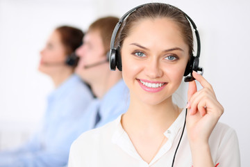 Call center operators. Young beautiful business woman in headset.  Male phone operator in headset...