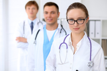 Fototapeta premium Happy doctor woman with medical staff at the hospital